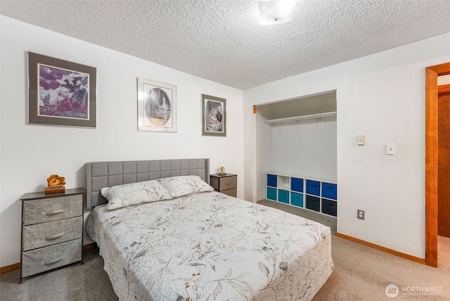 bedroom featuring carpet flooring, a textured ceiling, baseboards, and a closet