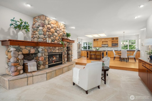 26108 SE 27th St, Sammamish, WA 98075 - living room with plenty of natural light, a fireplace, and light wood-type flooring