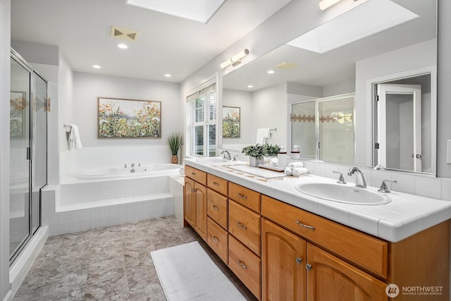 26108 SE 27th St, Sammamish, WA 98075 - full bathroom with a bath, a stall shower, a skylight, double vanity, and recessed lighting