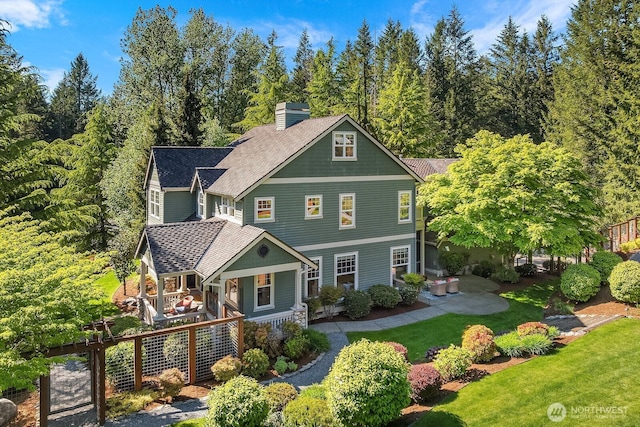 26108 SE 27th St, Sammamish, WA 98075 - shingle-style home featuring a porch, a front yard, a chimney, and roof with shingles