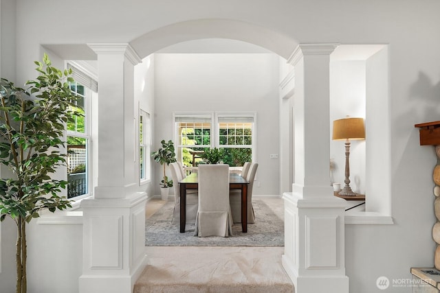 26108 SE 27th St, Sammamish, WA 98075 - dining area with ornate columns, light colored carpet, and arched walkways
