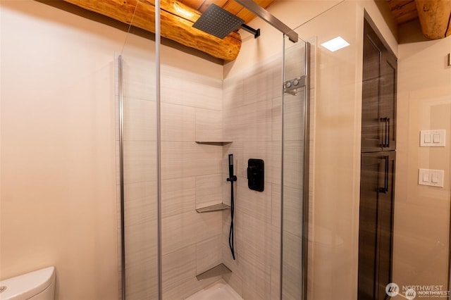 full bathroom with a stall shower and toilet