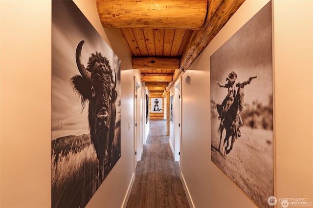 hall with wood ceiling, wood finished floors, beamed ceiling, and rustic walls