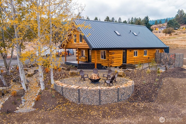1181 Elk Heights Rd, Cle Elum, WA 98922 - back of house featuring log siding, a fire pit, metal roof, and a standing seam roof