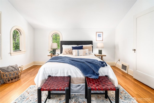 bedroom featuring wood finished floors and baseboards