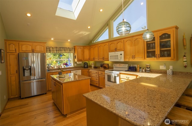 162 W Nelson Rd, Sequim, WA 98382 - kitchen featuring white appliances, a skylight, a peninsula, glass insert cabinets, and light stone countertops