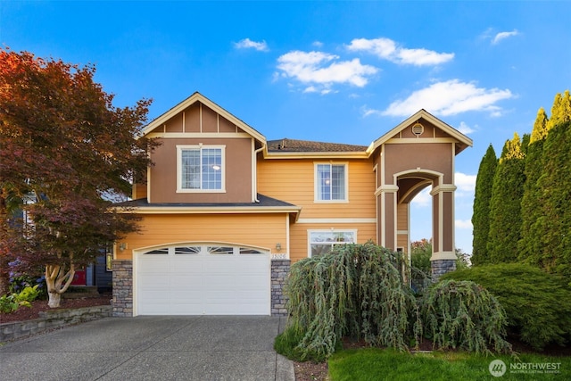 13106 SE 261st Pl, Kent, WA 98030 - view of front facade with driveway, stone siding, and an attached garage