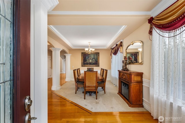 13106 SE 261st Pl, Kent, WA 98030 - dining area with a chandelier, light wood finished floors, decorative columns, ornamental molding, and wainscoting
