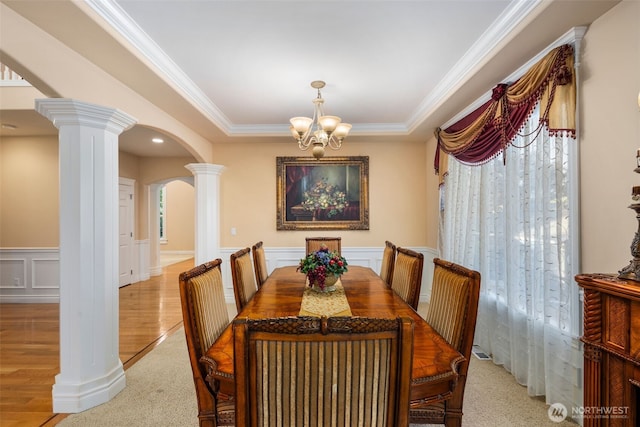 13106 SE 261st Pl, Kent, WA 98030 - dining room with arched walkways, ornate columns, ornamental molding, a chandelier, and a wainscoted wall