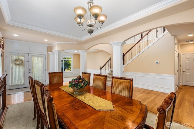 13106 SE 261st Pl, Kent, WA 98030 - dining area with ornate columns, a chandelier, crown molding, a decorative wall, and arched walkways