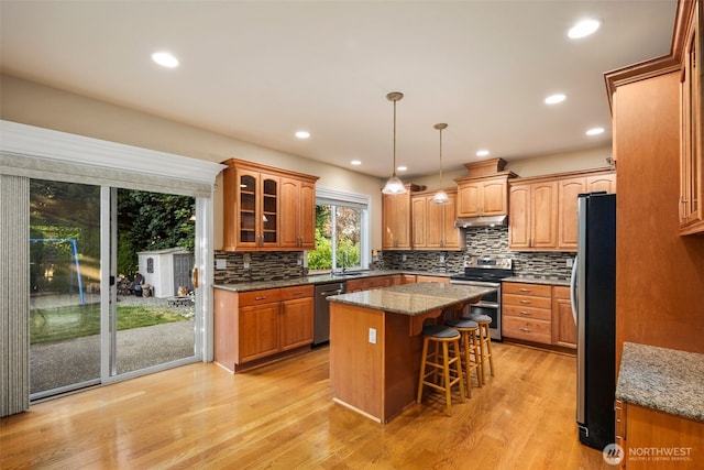 13106 SE 261st Pl, Kent, WA 98030 - kitchen featuring appliances with stainless steel finishes, a center island, a breakfast bar area, backsplash, and recessed lighting