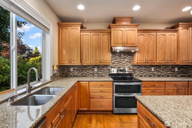 13106 SE 261st Pl, Kent, WA 98030 - kitchen featuring double oven range, under cabinet range hood, wood finished floors, light stone countertops, and recessed lighting