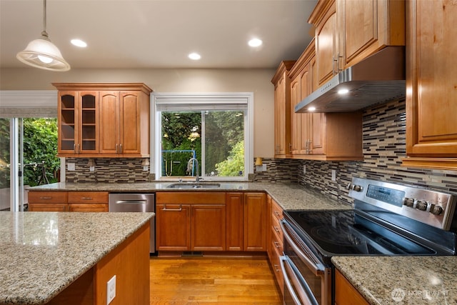 13106 SE 261st Pl, Kent, WA 98030 - kitchen with appliances with stainless steel finishes, light stone counters, under cabinet range hood, light wood-style floors, and recessed lighting
