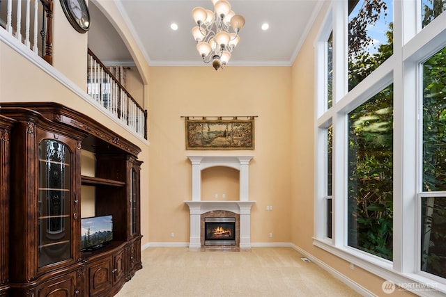 13106 SE 261st Pl, Kent, WA 98030 - unfurnished living room featuring a chandelier, light colored carpet, a tile fireplace, a towering ceiling, and ornamental molding
