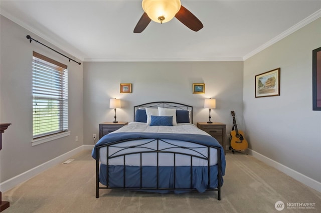 carpeted bedroom with crown molding, baseboards, and ceiling fan