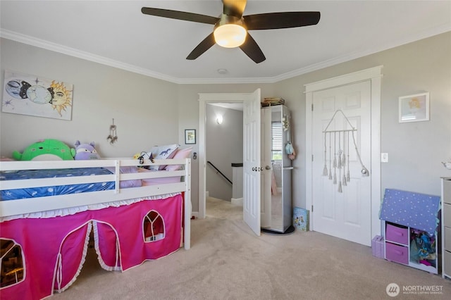 bedroom featuring crown molding, carpet floors, and a ceiling fan