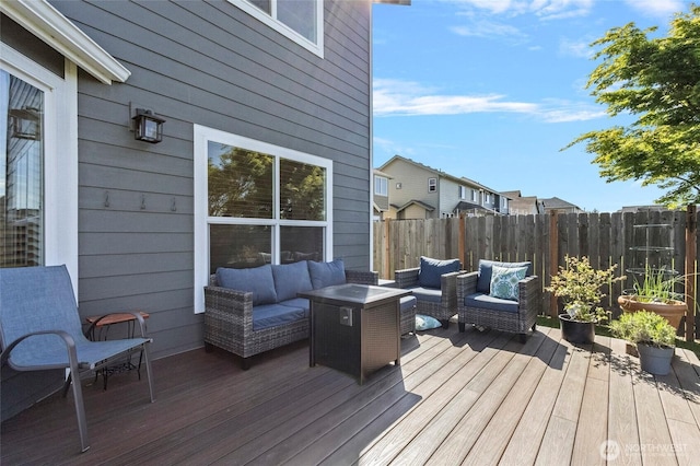deck featuring outdoor lounge area and fence