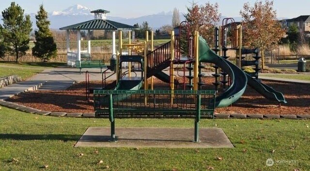 communal playground with a lawn and a gazebo