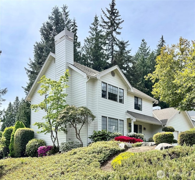 332 162nd Pl SE, Bothell, WA 98012 - view of home's exterior with a chimney and a shingled roof