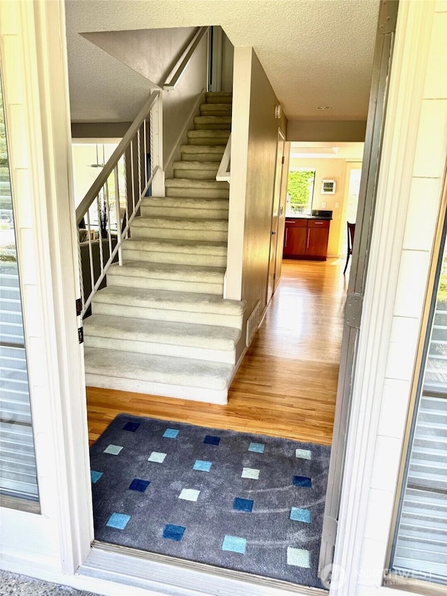 332 162nd Pl SE, Bothell, WA 98012 - stairway featuring wood finished floors and a textured ceiling