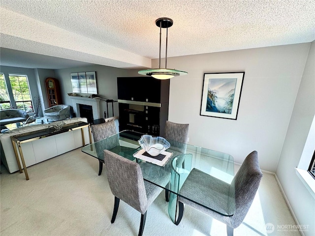 332 162nd Pl SE, Bothell, WA 98012 - dining room featuring a textured ceiling, light colored carpet, and a fireplace