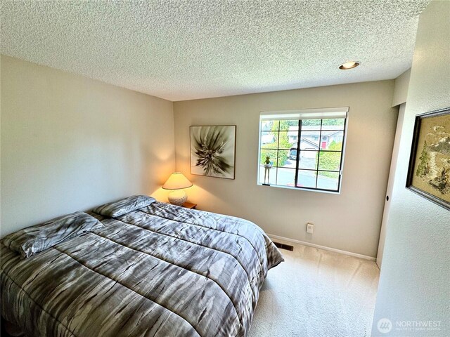332 162nd Pl SE, Bothell, WA 98012 - carpeted bedroom with a textured ceiling and baseboards