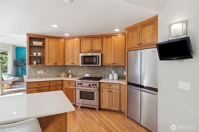 702 Woodland Dr, Port Townsend, WA 98368 - kitchen with appliances with stainless steel finishes, light countertops, open shelves, decorative backsplash, and recessed lighting