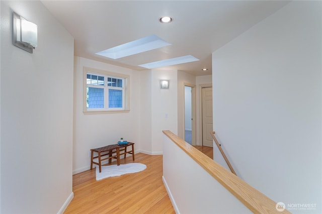 702 Woodland Dr, Port Townsend, WA 98368 - hallway with an upstairs landing, a skylight, light wood-type flooring, recessed lighting, and baseboards