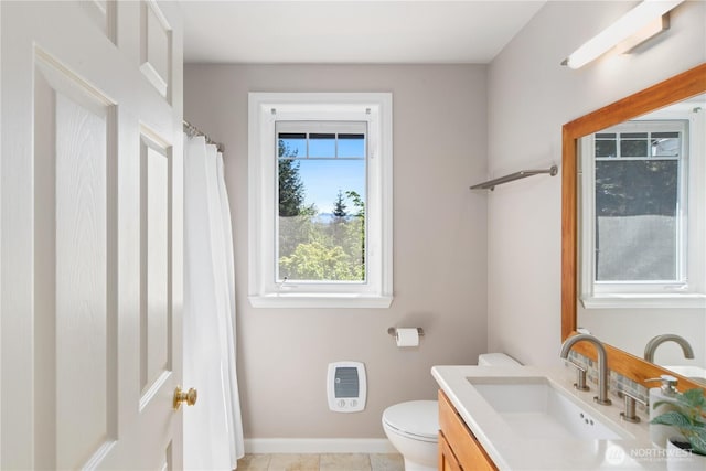 702 Woodland Dr, Port Townsend, WA 98368 - full bathroom with heating unit, toilet, vanity, baseboards, and tile patterned floors