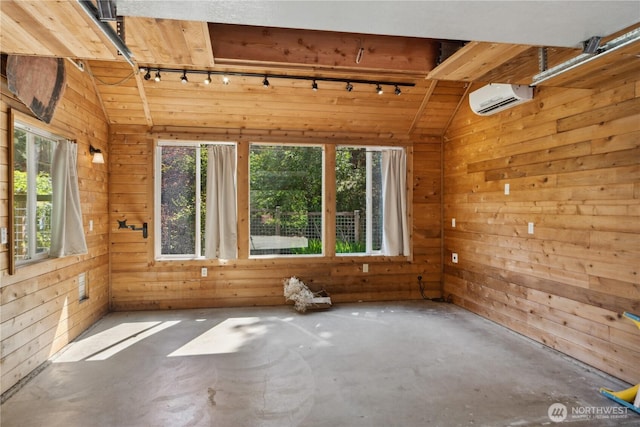 702 Woodland Dr, Port Townsend, WA 98368 - spare room with track lighting, a wall mounted air conditioner, wood walls, concrete floors, and lofted ceiling