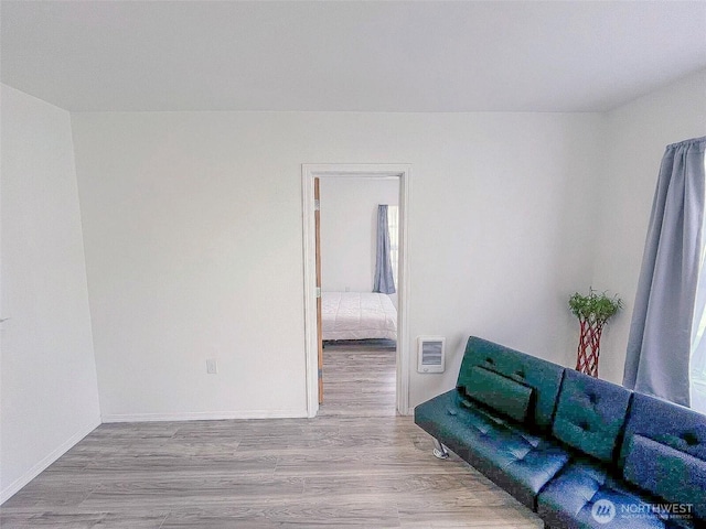 unfurnished living room with wood finished floors and baseboards