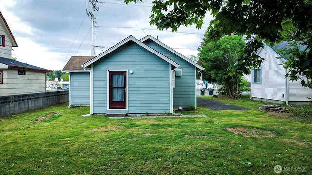 rear view of house with a yard