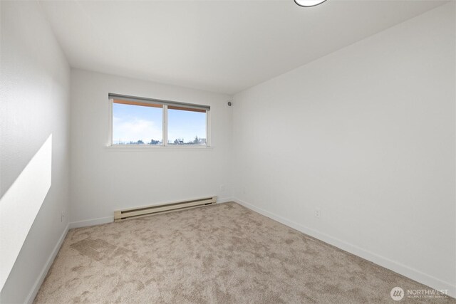 3121 W Hood Ave Unit E203, Kennewick, WA 99336 - unfurnished room featuring a baseboard heating unit, carpet flooring, and baseboards