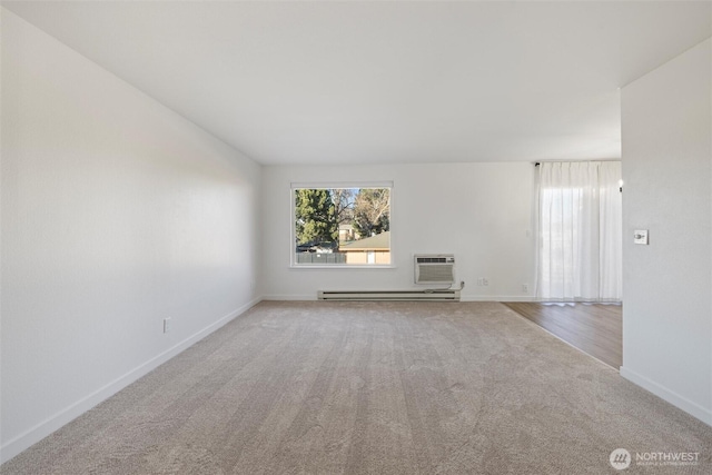 3121 W Hood Ave Unit E203, Kennewick, WA 99336 - unfurnished room featuring a baseboard heating unit, carpet flooring, an AC wall unit, and baseboards