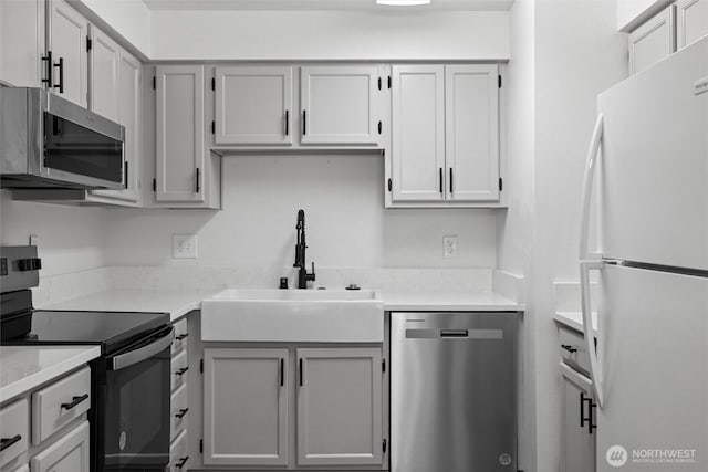3121 W Hood Ave Unit E203, Kennewick, WA 99336 - kitchen with stainless steel appliances, a sink, light countertops, and gray cabinetry