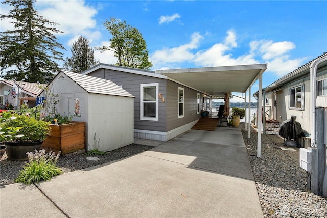 4805 Cushman Rd NE Unit 61, Olympia, WA 98506 - view of front of house with a storage shed, an outbuilding, an attached carport, and concrete driveway