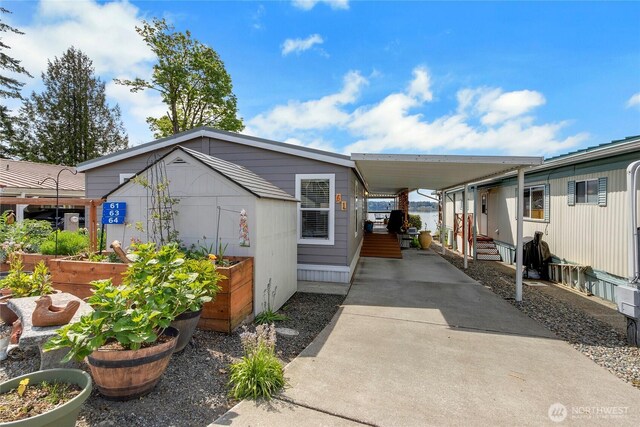 4805 Cushman Rd NE Unit 61, Olympia, WA 98506 - view of front of home with a vegetable garden, driveway, and an attached carport