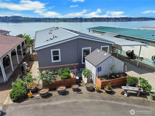 4805 Cushman Rd NE Unit 61, Olympia, WA 98506 - view of front facade with a vegetable garden, a water view, and fence