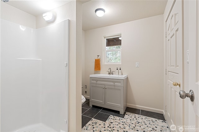 30521 NE 147th Ct, Battle Ground, WA 98604 - full bath featuring a shower, tile patterned flooring, toilet, vanity, and baseboards