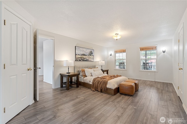 30521 NE 147th Ct, Battle Ground, WA 98604 - bedroom with wood finished floors, a textured ceiling, and baseboards