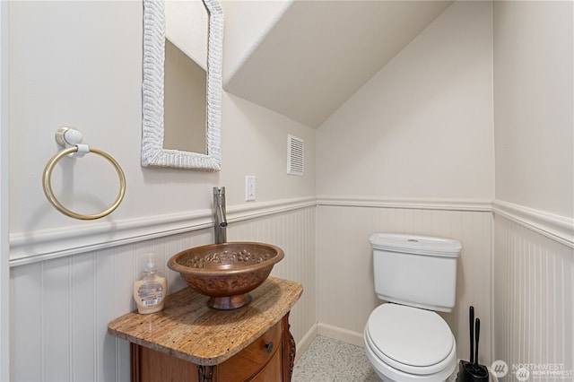 30521 NE 147th Ct, Battle Ground, WA 98604 - half bath featuring a wainscoted wall, vanity, toilet, and lofted ceiling