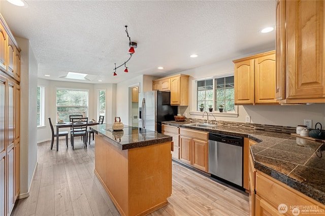30521 NE 147th Ct, Battle Ground, WA 98604 - kitchen featuring stainless steel appliances, tile countertops, a textured ceiling, a sink, and a center island