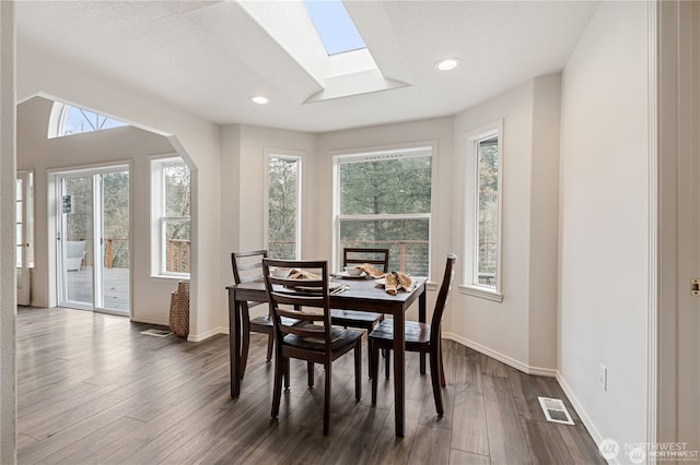 30521 NE 147th Ct, Battle Ground, WA 98604 - dining room featuring a skylight, healthy amount of natural light, dark wood finished floors, baseboards, and recessed lighting