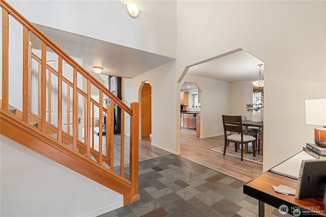 30521 NE 147th Ct, Battle Ground, WA 98604 - entrance foyer with arched walkways, stairs, baseboards, a high ceiling, and wood finished floors