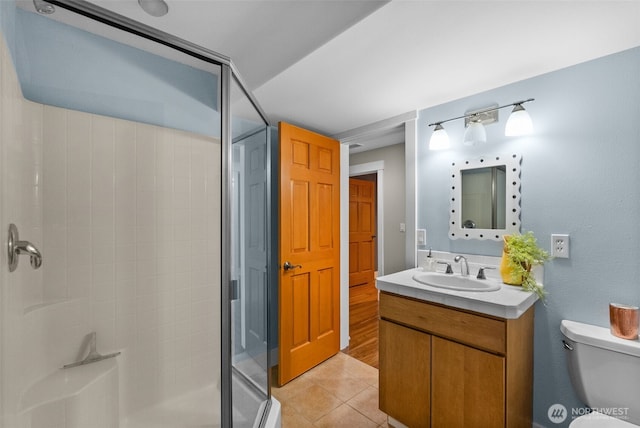 257 3rd Ave, Fox Island, WA 98333 - bathroom featuring a shower stall, tile patterned floors, toilet, and vanity