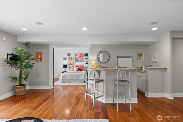 257 3rd Ave, Fox Island, WA 98333 - kitchen with a kitchen breakfast bar, wood finished floors, baseboards, and recessed lighting