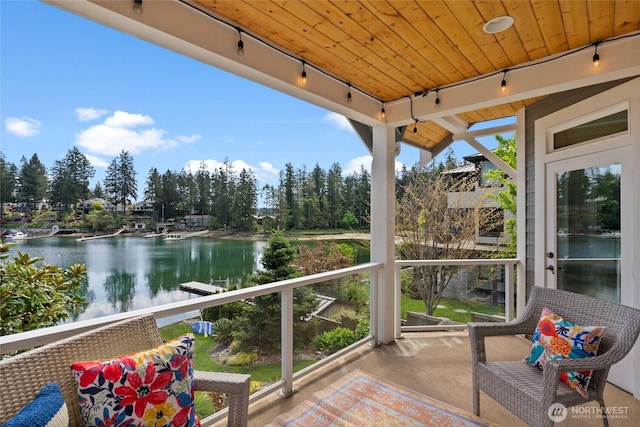 257 3rd Ave, Fox Island, WA 98333 - sunroom featuring rail lighting, a water view, and carpet flooring
