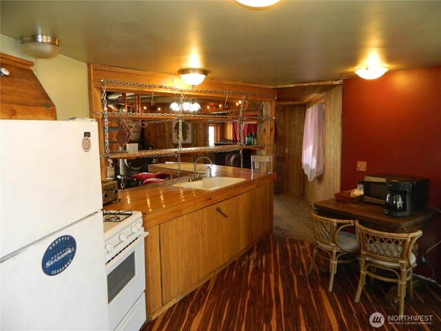0 High Country Dr W, Tonasket, WA 98855 - kitchen with white appliances, a sink, dark wood finished floors, and brown cabinetry