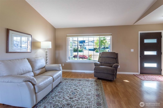 6130 Pacific Heights Dr, Ferndale, WA 98248 - living area with wood finished floors, baseboards, and lofted ceiling