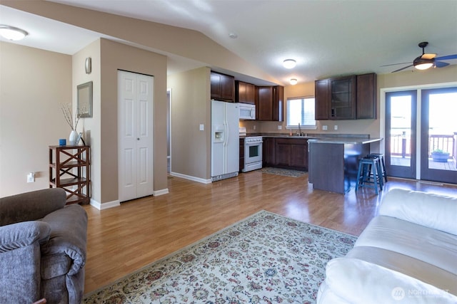 6130 Pacific Heights Dr, Ferndale, WA 98248 - living room featuring light wood-type flooring, vaulted ceiling, baseboards, and a ceiling fan